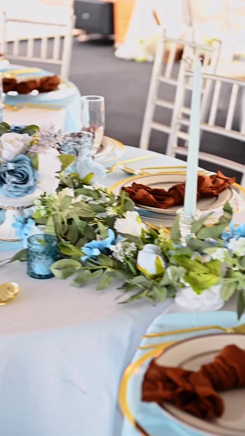 Formal event table with blue runner and terracotta candles. Side view of an Stock Footage 329511416