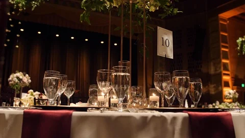 Formal luxury wedding table setting with candles, gold plates and, flowers 動画素材 104820320