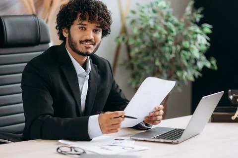 Formal portrait of successful confident curly-haired Indian man, top manager Stock-Fotos