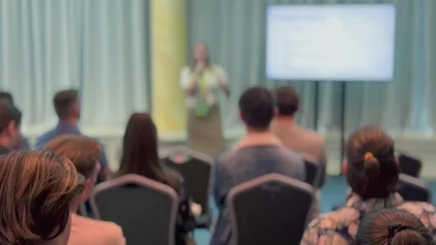 Formal presentation in conference room with attentive audience and speaker at Stock Footage 319986731