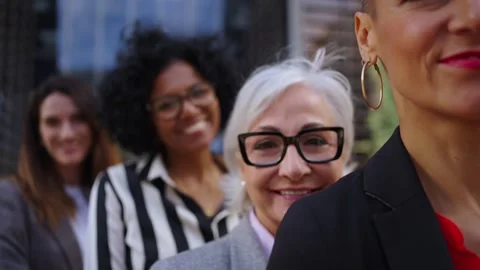Formal work group of diverse business women standing in a row looking serious to Stock Footage 270987171