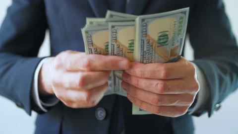 Formally dressed man counting US Dollar bills. Concept of investment, success Stock Footage 201966426