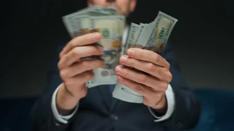 Formally dressed man counting US Dollar bills, close-up. Stock Footage 229425369