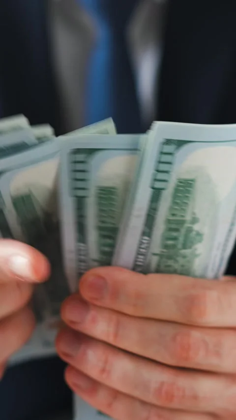 Formally dressed man counting US Dollar bills, close-up. Stock Footage 284443417