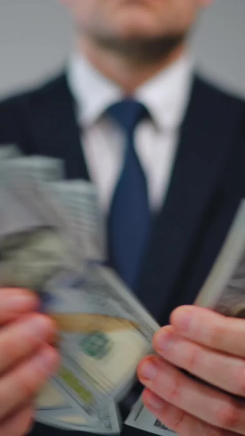Formally dressed man is counting US Dollar bills, close-up. Stock Footage 288468669