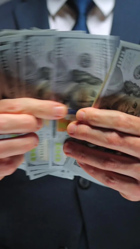 Formally dressed man counting US Dollar bills, close-up. Stock Footage 317717857