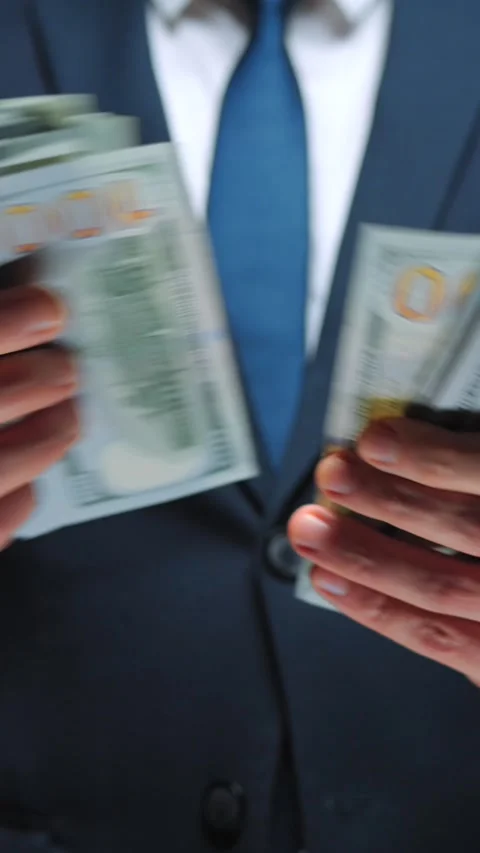 Formally dressed man is counting US Dollar bills, close-up. Stock Footage 318004569