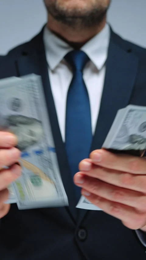 Formally dressed man is counting US Dollar bills, close-up. Video stock 340407741