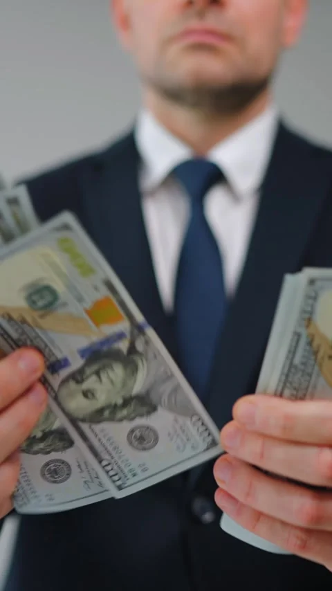 Formally dressed man is counting US Dollar bills quickly, close-up. Stock Footage 342832561
