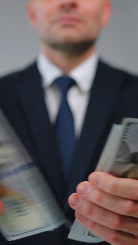 Formally dressed man is counting US Dollar bills, close-up. Video stock 342833874