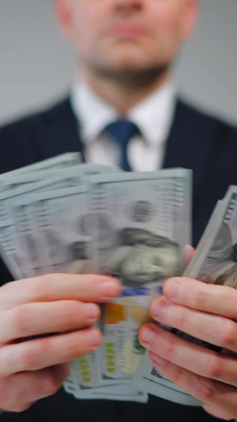 Formally dressed man is counting US Dollar bills quickly, close-up. Video stock 342834400