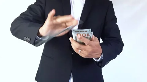 Formally dressed man makes money rain from US dollar bills. Stock Footage 288975168