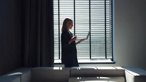 Formally dressed woman using wireless laptop for video call at dark office Stock-Footage 251815672