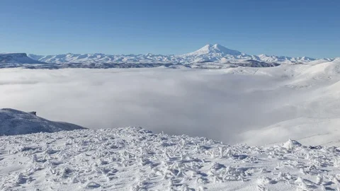 The formation and movement of clouds above the volcano Elbrus Stock Footage 70408347