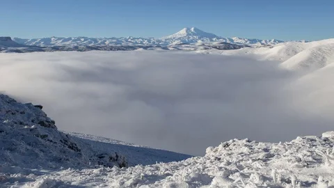 The formation and movement of clouds above the volcano Elbrus Stock Footage 70409245