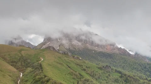 The formation and movement of clouds over the summer slopes of Bolshoy Thach Stock Footage 83493101