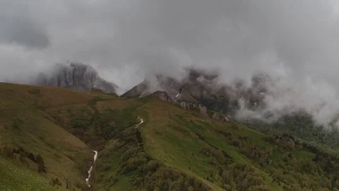 The formation and movement of clouds over the summer slopes of Bolshoy Thach Stock Footage 83493118