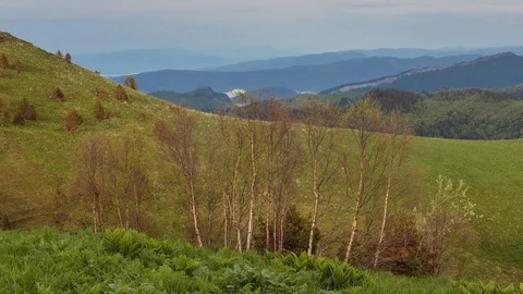 The formation and movement of clouds over the summer slopes of Bolshoy Thach Stock Footage 83493131