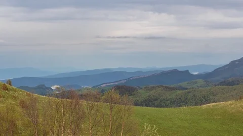 The formation and movement of clouds over the summer slopes of Bolshoy Thach Stock Footage 83493138
