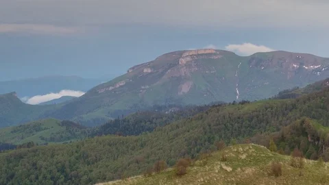 The formation and movement of clouds over the summer slopes of Bolshoy Thach Stock Footage 83493144