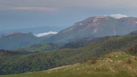 The formation and movement of clouds over the summer slopes of Bolshoy Thach Stock Footage 83493158