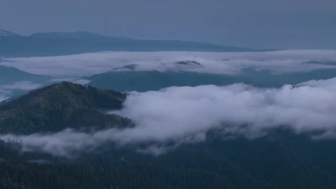 The formation and movement of clouds over the summer slopes of Bolshoy Thach Stock Footage 83493160