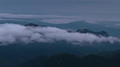 The formation and movement of clouds over the summer slopes of Bolshoy Thach Stock Footage 83493172