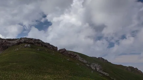 The formation and movement of clouds over the summer slopes of Bolshoy Thach Stock Footage 83493191