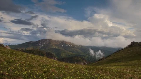 The formation and movement of clouds over the summer slopes of Bolshoy Thach Stock Footage 83493197
