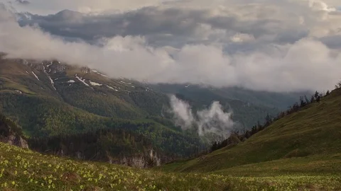 The formation and movement of clouds over the summer slopes of Bolshoy Thach Stock Footage 83493198