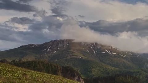 The formation and movement of clouds over the summer slopes of Bolshoy Thach Stock Footage 83493201
