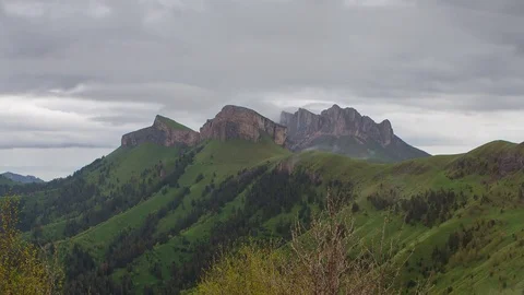 The formation and movement of clouds over the summer slopes of Bolshoy Thach Stock Footage 83493225