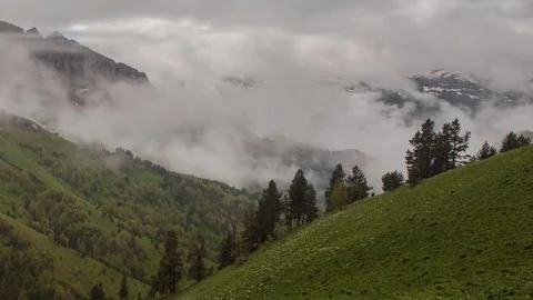 The formation and movement of clouds over the summer slopes of Bolshoy Thach Stock Footage 83493255