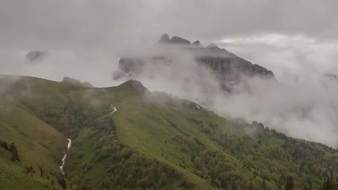 The formation and movement of clouds over the summer slopes of Bolshoy Thach Stock Footage 83493258