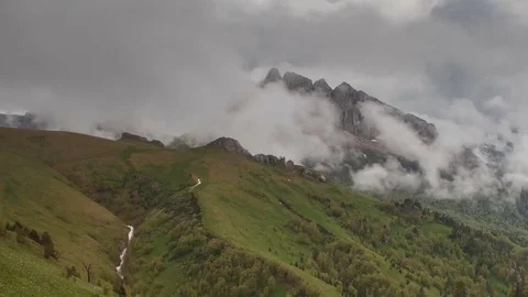 The formation and movement of clouds over the summer slopes of Bolshoy Thach Stock Footage 83493269