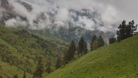 The formation and movement of clouds over the summer slopes of Bolshoy Thach Stock Footage 83493277