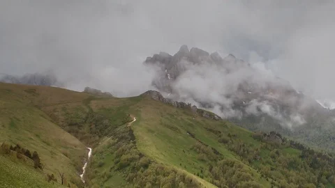The formation and movement of clouds over the summer slopes of Bolshoy Thach Stock Footage 83493306