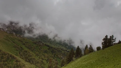 The formation and movement of clouds over the summer slopes of Bolshoy Thach Stock Footage 83493324