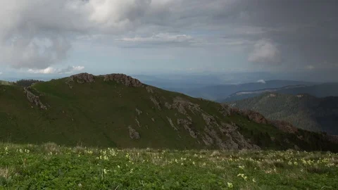 The formation and movement of clouds over the summer slopes of Bolshoy Thach Stock Footage 83493346