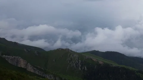 The formation and movement of clouds over the summer slopes of Bolshoy Thach Stock Footage 83493351
