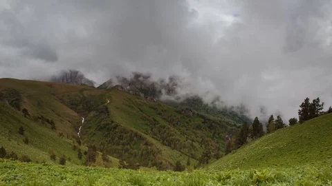 The formation and movement of clouds over the summer slopes of Bolshoy Thach Stock Footage 83493365
