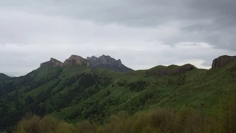 The formation and movement of clouds over the summer slopes of Bolshoy Thach Stock Footage 83493389
