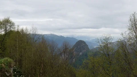 The formation and movement of clouds over the summer slopes of Bolshoy Thach Stock Footage 83493399