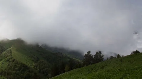 The formation and movement of clouds over the summer slopes of Bolshoy Thach Stock Footage 83493412