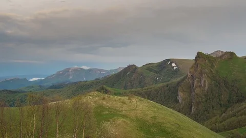 The formation and movement of clouds over the summer slopes of Bolshoy Thach Stock Footage 83493440