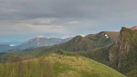 The formation and movement of clouds over the summer slopes of Bolshoy Thach Stock Footage 83493443