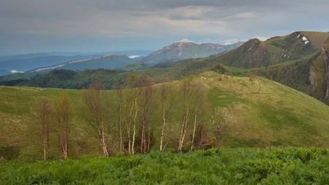 The formation and movement of clouds over the summer slopes of Bolshoy Thach Stock Footage 83493447