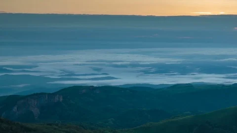 The formation and movement of clouds over the summer slopes of Bolshoy Thach Stock Footage 83493470
