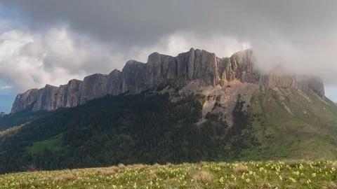 The formation and movement of clouds over the summer slopes of Bolshoy Thach Stock Footage 83493521