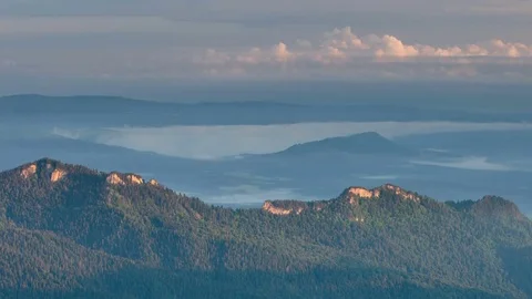 The formation and movement of clouds over the summer slopes of Bolshoy Thach Stock Footage 83493522